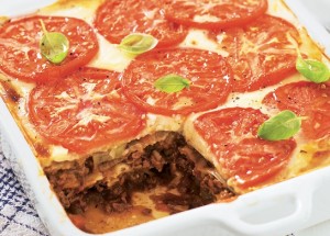 Lasagne topped with cheese and tomato